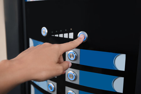 Woman choosing hot drink in coffee vending machine, closeup