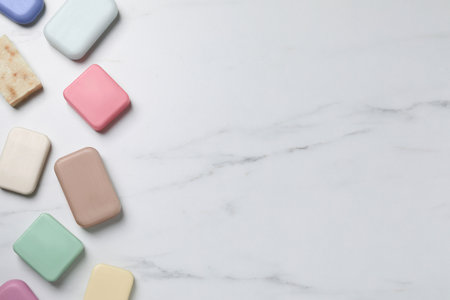 Many different soap bars on white marble table, flat lay. Space for textの写真素材