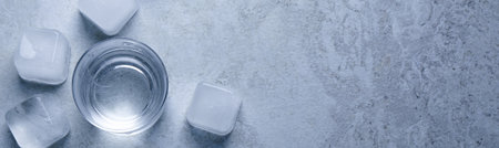 Shot glasses of vodka with ice on light gray table, flat lay with space for text. banner design