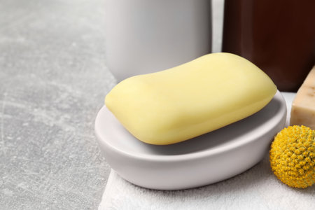 Dish with soap bar on light gray table, closeup. Space for textの写真素材