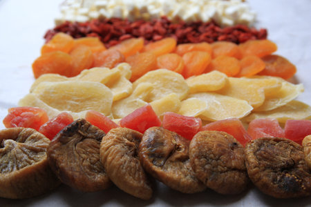 Different tasty dried fruits on paper, closeupの写真素材