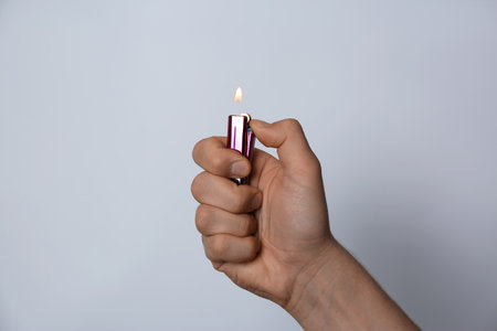 Man holding lighter on white background, closeup