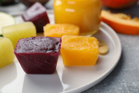 Frozen beet, pumpkin and zucchini puree cubes on plate, closeupの写真素材