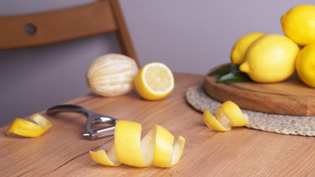 Lemon zest. Rind, fresh fruits and peeler on wooden tableの写真素材