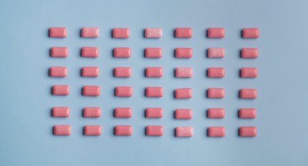 Many sweet chewing gums on light blue background, flat lay