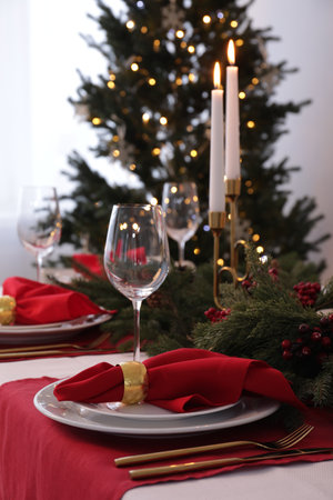Beautiful place setting with Christmas decor on table indoorsの写真素材