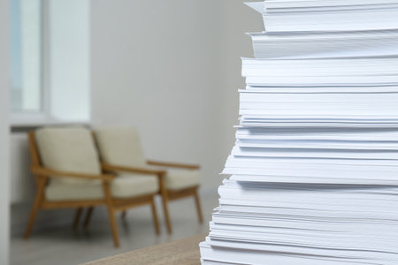 Stack of paper sheets on wooden table indoors, closeup. Space for textの写真素材