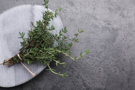 Bunch of fresh thyme on gray table, top view. Space for textの写真素材