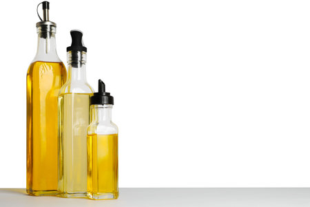 Bottles of different cooking oils on white background, space for textの写真素材