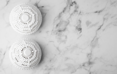 Laundry dryer balls on white marble table, flat lay. Space for textの写真素材