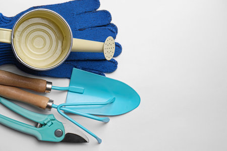 Watering can, gardening tools and gloves on white background, flat layの写真素材