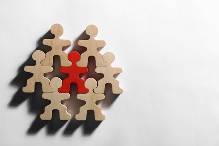 Red figure among wooden ones on white background, flat lay with space for text. Recruiter searching employeeの写真素材