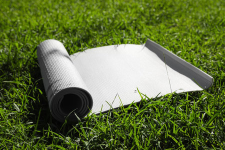 Karemat or fitness mat on green grass outdoorsの写真素材