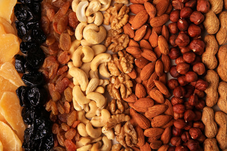 Mix of delicious dried nuts and fruits as background, top viewの写真素材