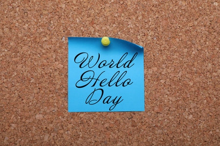 Paper note with phrase World Hello Day pinned to cork boardの写真素材