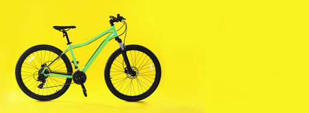 Modern bicycle on yellow background, space for text. banner design
