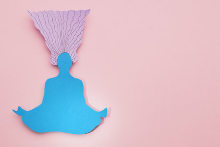 Woman paper figure on pink background, top view. Space for textの写真素材