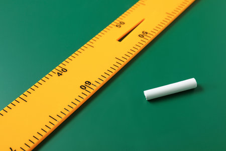 Ruler and chalk on green chalkboard, closeupの写真素材