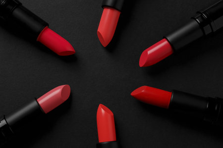 Beautiful lipsticks on black background, flat layの写真素材