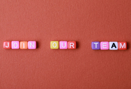 Colorful cubes with phrase Join Our Team on red background, flat lay. Recruiter searching employeeの写真素材