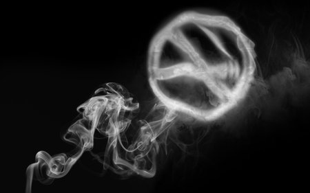 No smoking. Round sign with crossed cigarette of smoke on black backgroundの写真素材