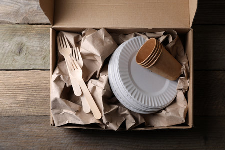 Box of waste paper on wooden table, top viewの写真素材
