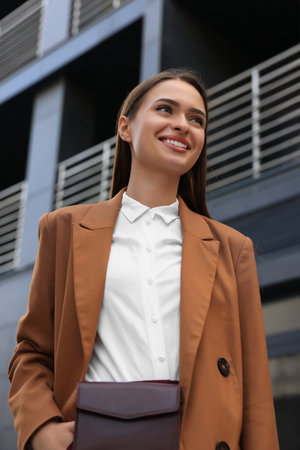 Young woman in formal clothes near building outdoorsの写真素材