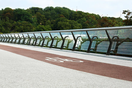 modern bridge with bike lane over riverの写真素材