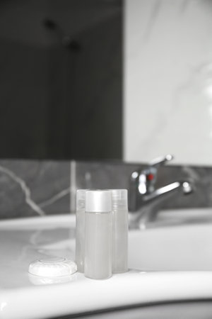 Bottles of shower gel on sink in bathroom