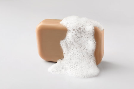 Soap with fluffy foam on white backgroundの写真素材