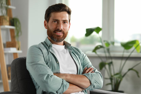 Portrait of handsome bearded man at home, space for textの写真素材