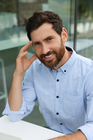 Portrait of handsome bearded man in outdoor cafeの写真素材