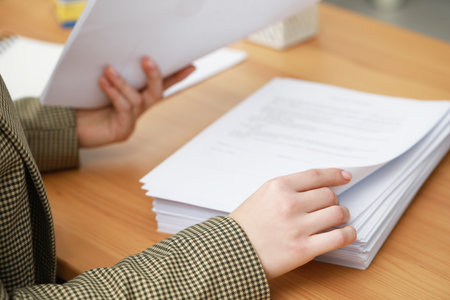 Woman working with documents at table in office, closeupの写真素材