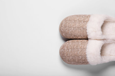 Pair of beautiful soft slippers on white background, top view. Space for textの写真素材