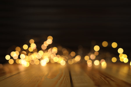 Empty wooden surface and blurred lights on background. bokeh effect