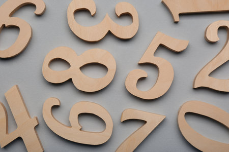 Wooden numbers on light gray background, flat layの写真素材