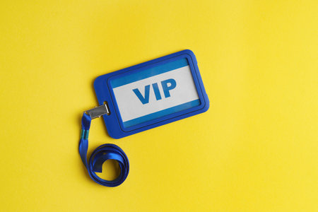 Vip badge on yellow background, top viewの写真素材