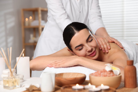 Beautiful woman receiving back massage in beauty salon, closeupの写真素材