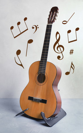 Acoustic guitar, music notes and other musical symbols indoorsの写真素材
