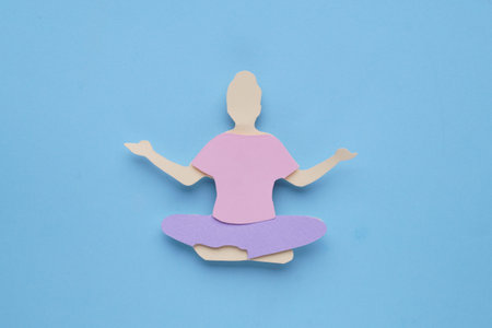 woman's health. Paper female figure on light blue background, top viewの写真素材