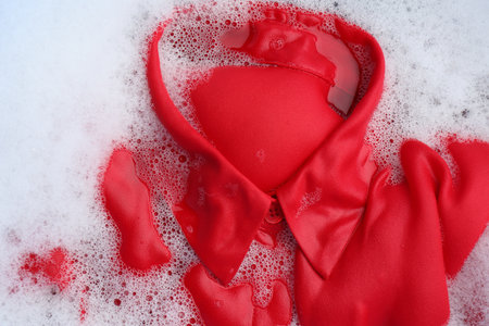 Color clothing in suds, top view. hand washing laundryの写真素材