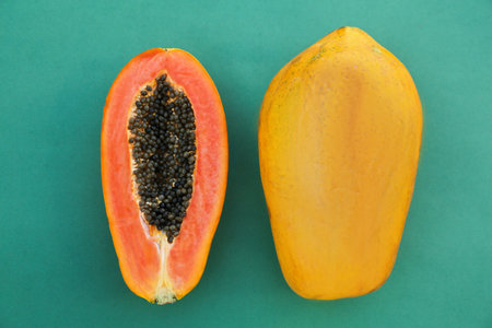 Fresh ripe cut and whole papaya fruits on light blue background, flat layの写真素材