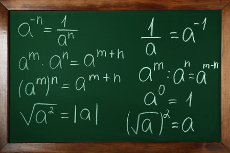 Many different math formulas written on chalkboard, closeup