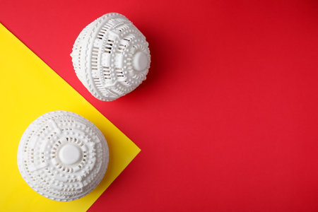 Laundry dryer balls on color background, flat lay. Space for textの写真素材