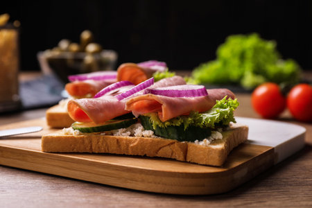 Delicious sandwiches with ham on wooden table, closeupの写真素材