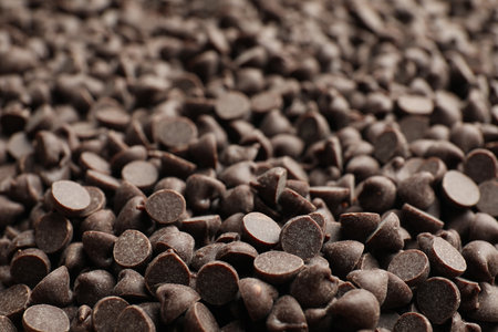Delicious chocolate chips as background, closeup viewの写真素材