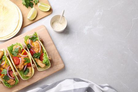 Yummy fish tacos served on marble table, flat lay. Space for textの写真素材