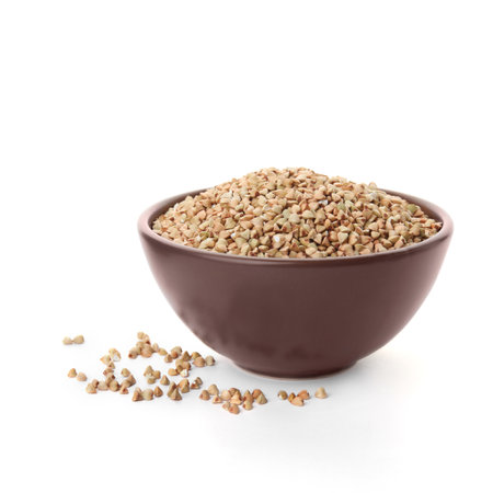 Organic green buckwheat in bowl isolated on whiteの写真素材