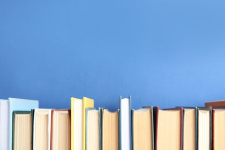 Collection of old books on blue background. Space for textの写真素材