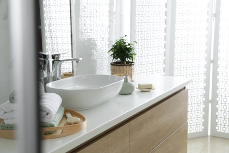 Modern bathroom interior with stylish mirror and vessel sinkの写真素材